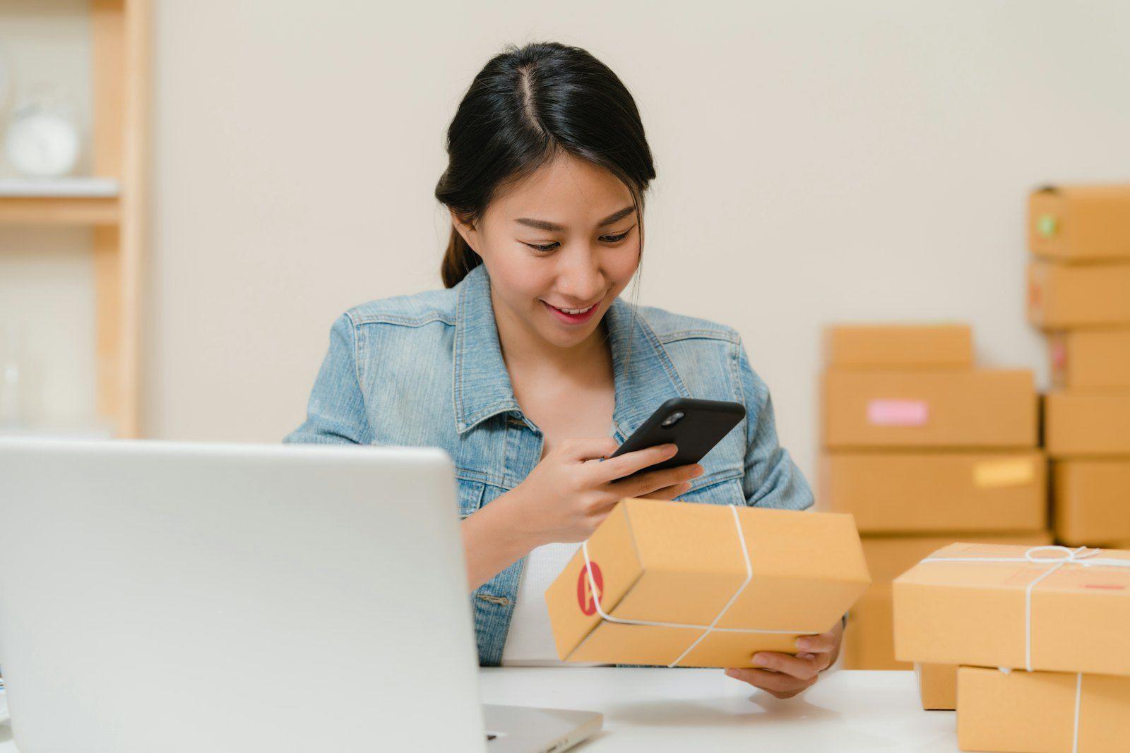 E-commerce owner preparing an order with a phone in hand