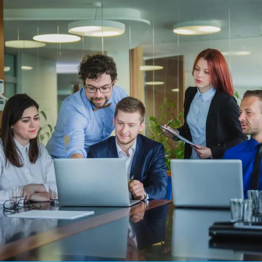 Team meeting with laptops in a bright office