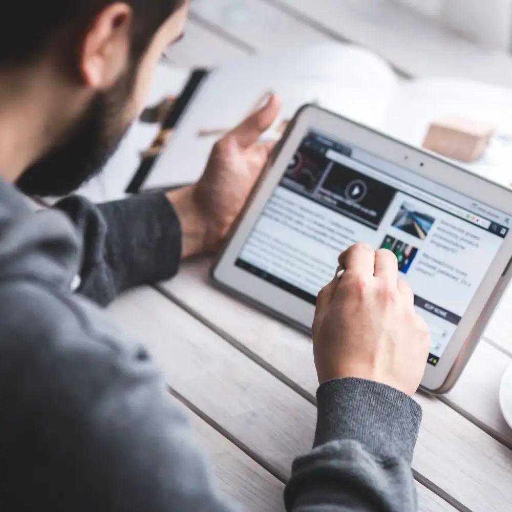 Person reading an article on a tablet